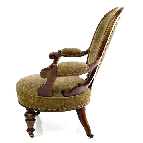 1859 - A Victorian walnut spoon back armchair, with padded back, arms, and seat and with carved and scroll ... 