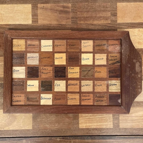 1864 - A Ghanian hardwood coffee table, circa 1960s, the rectangular top inlaid with forty African hardwood... 