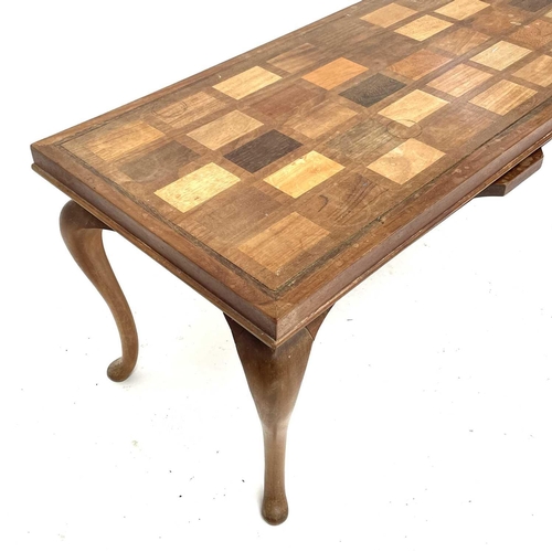 1864 - A Ghanian hardwood coffee table, circa 1960s, the rectangular top inlaid with forty African hardwood... 