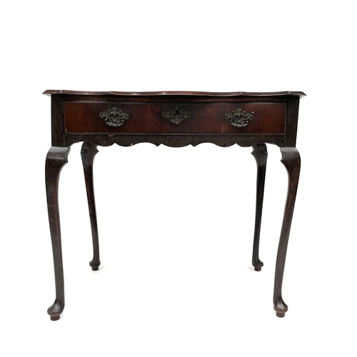 1873 - An early 18th century mahogany side table, the rectangular top with shaped edge above a long drawer ... 