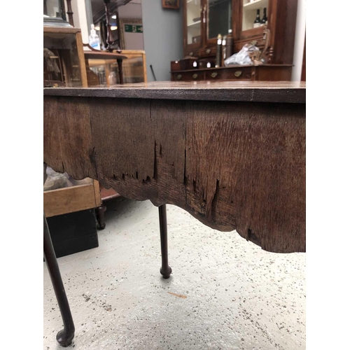 1873 - An early 18th century mahogany side table, the rectangular top with shaped edge above a long drawer ... 