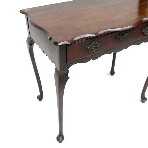 1873 - An early 18th century mahogany side table, the rectangular top with shaped edge above a long drawer ... 