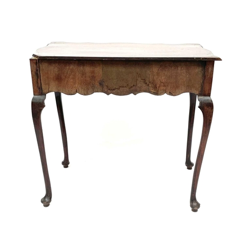 1873 - An early 18th century mahogany side table, the rectangular top with shaped edge above a long drawer ... 