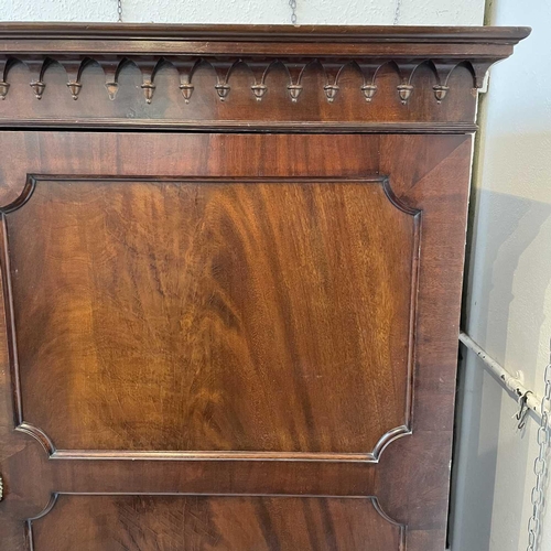 1876 - A 19th century mahogany wardrobe, with arcaded cornice above two panel doors, one enclosing hanging ... 