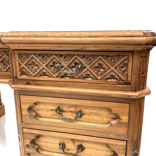 1878 - A pine partner's pedestal desk, 20th century, the upper drawers with Gothic carved fronts, and with ... 