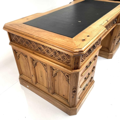 1878 - A pine partner's pedestal desk, 20th century, the upper drawers with Gothic carved fronts, and with ... 