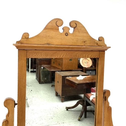 1879 - An Edwardian pine dressing table, with a swing mirror and four drawers on turned legs, height 159cm,... 