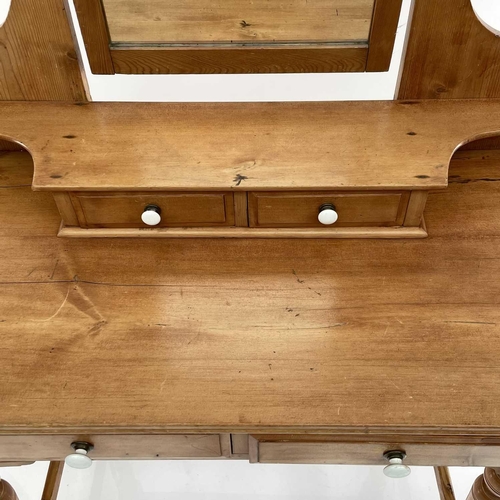 1879 - An Edwardian pine dressing table, with a swing mirror and four drawers on turned legs, height 159cm,... 