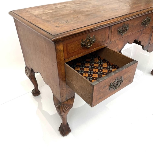 1881 - A Queen Anne style Walnut kneehole side table, late 19th century, fitted with 5 drawers around a sha... 