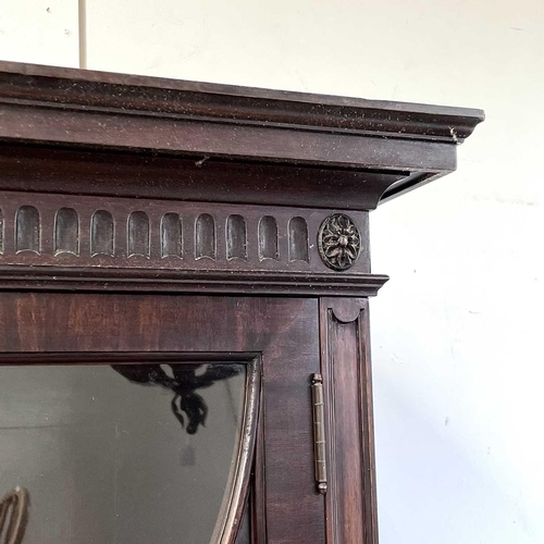 1882 - A George III style mahogany bookcase cabinet, circa 1900, with fluted frieze above two glazed doors,... 