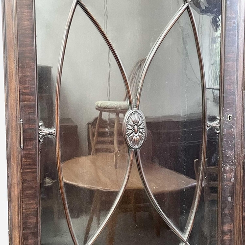 1882 - A George III style mahogany bookcase cabinet, circa 1900, with fluted frieze above two glazed doors,... 