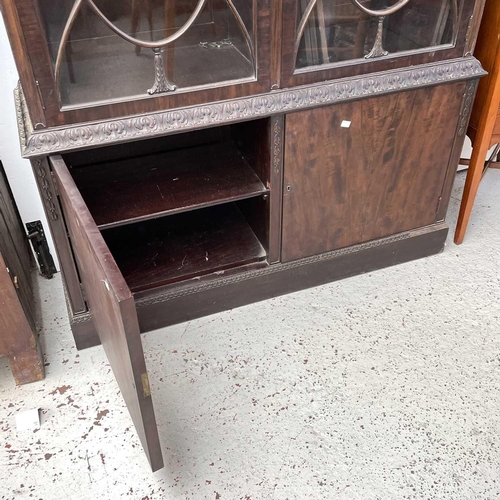 1882 - A George III style mahogany bookcase cabinet, circa 1900, with fluted frieze above two glazed doors,... 