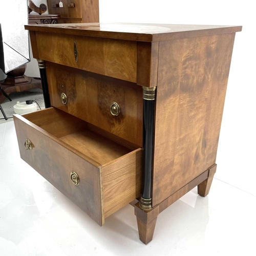 1884 - A Biedermeier style walnut chest of three long drawers, 20th century, with brass capped half column ... 