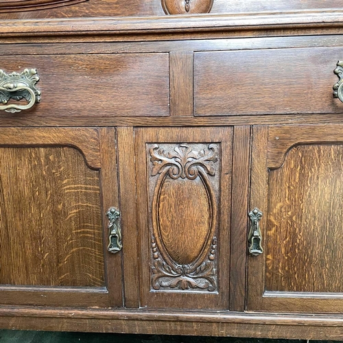 1893 - An Edwardian oak sideboard, fitted twp drawers and two doors on carved cabriole legs, height 124cm, ... 