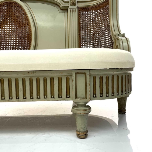 1894 - A French green painted and gilt Bergere settee, early 20th century, with bowed caned back above a fl... 