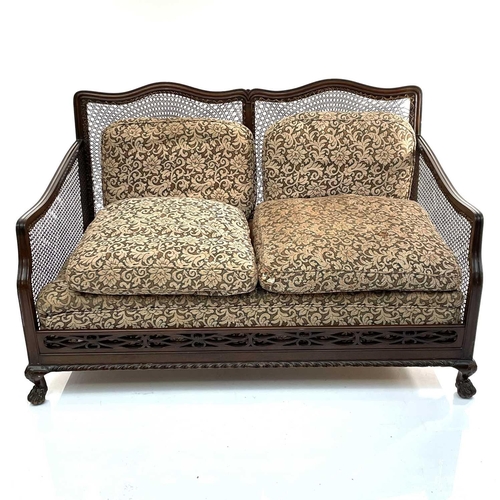 1896 - A walnut framed three piece Bergere suite, circa 1920, with loose cushions on carved ball and claw f... 