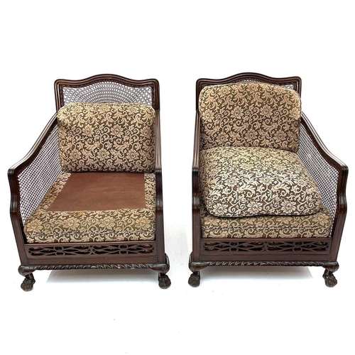 1896 - A walnut framed three piece Bergere suite, circa 1920, with loose cushions on carved ball and claw f... 