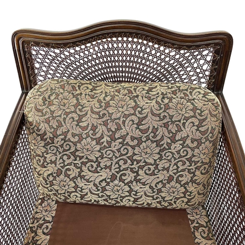 1896 - A walnut framed three piece Bergere suite, circa 1920, with loose cushions on carved ball and claw f... 