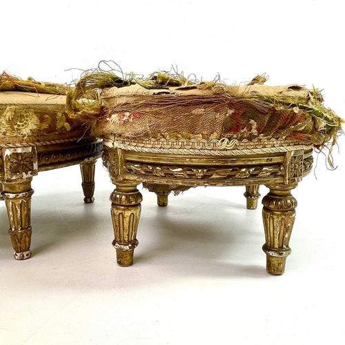 1899 - Two similar French giltwood oval footstools, circa 1860, each with a carved frieze and on turned and... 