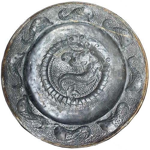 19 - A J.&F.Pool, Hayle copper charger, repousse decorated with a central dolphin, with further dolphins ... 