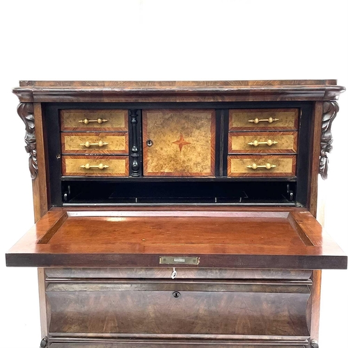 1907 - A Continental figured mahogany secretaire a abbatant, with drop down top enclosing a fitted interior... 