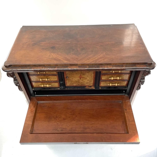 1907 - A Continental figured mahogany secretaire a abbatant, with drop down top enclosing a fitted interior... 