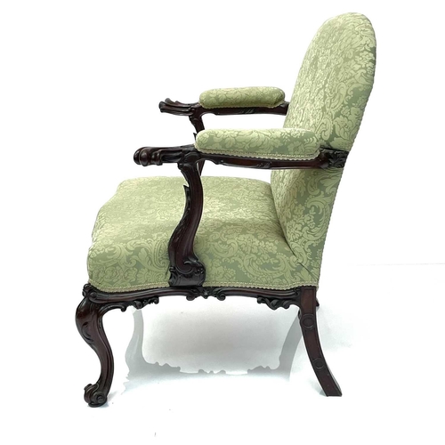 1910 - A George III mahogany Gainsborough type open armchair, the padded arms with prominent moulded outswe... 