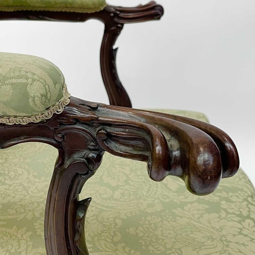 1910 - A George III mahogany Gainsborough type open armchair, the padded arms with prominent moulded outswe... 