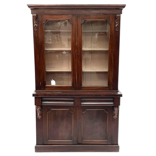 1916 - A Victorian mahogany bookcase cabinet, the upper part with moulded cornice above two glazed doors, t... 