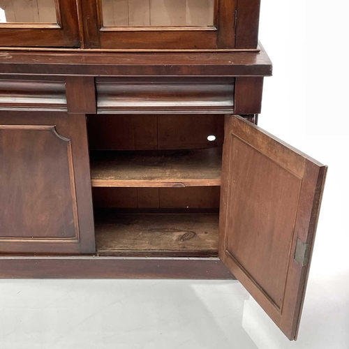 1916 - A Victorian mahogany bookcase cabinet, the upper part with moulded cornice above two glazed doors, t... 