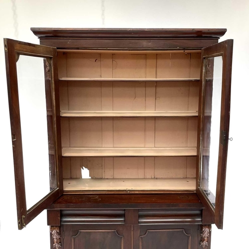 1916 - A Victorian mahogany bookcase cabinet, the upper part with moulded cornice above two glazed doors, t... 