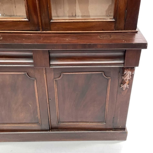 1916 - A Victorian mahogany bookcase cabinet, the upper part with moulded cornice above two glazed doors, t... 