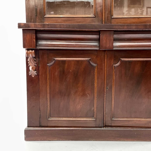 1916 - A Victorian mahogany bookcase cabinet, the upper part with moulded cornice above two glazed doors, t... 