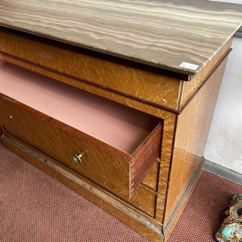 1922 - A Biedermeier maple chest, with a gray marble top above four long drawers and raised on a plinth bas... 