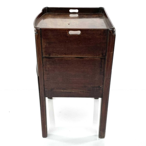 1929 - A George III mahogany night table, with a gallery top above a tambour front cupboard and pull-out dr... 