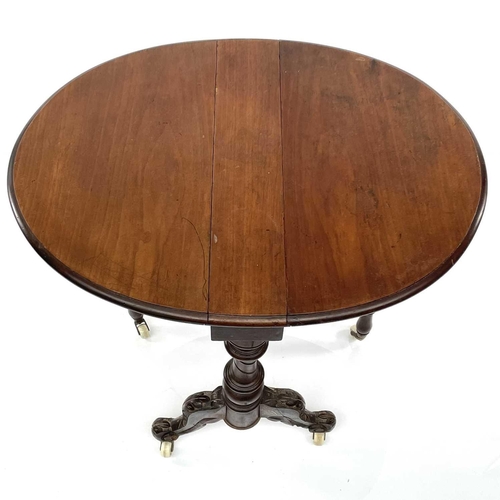 1930 - A Victorian walnut small Sutherland table, with oval twin flaps on a turned and carved underframe, h... 