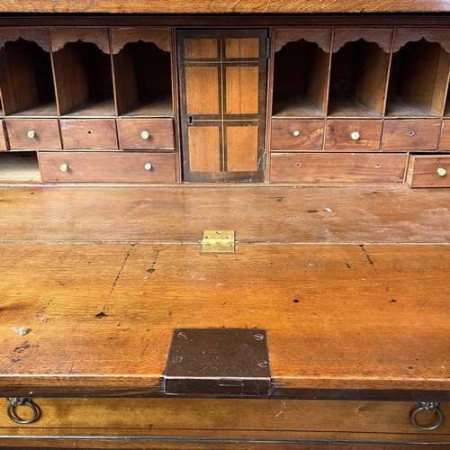 1935 - A George III mahogany secretaire chest. The large frieze drawer opening to reveal a fitted interior,... 