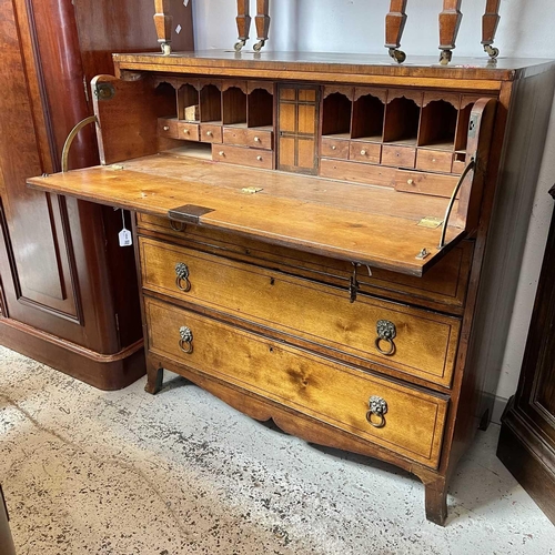 1935 - A George III mahogany secretaire chest. The large frieze drawer opening to reveal a fitted interior,... 