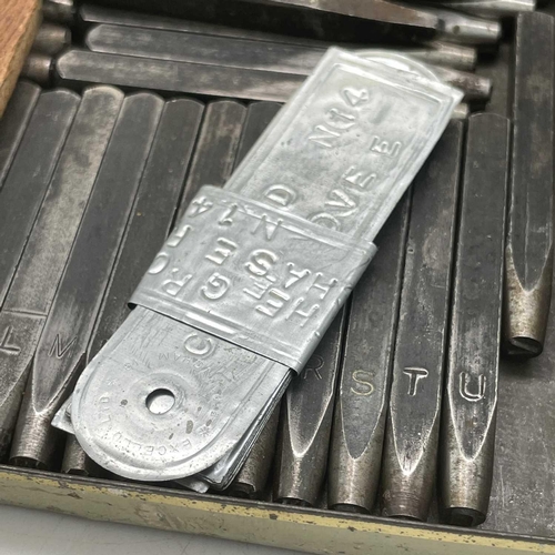 198 - A set of complete steel letter and number punches and a brass block.