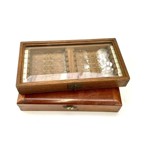 199 - A set of twelve Opticians lenses, with gilt metal fittings, contained in a glazed top oak case, widt... 