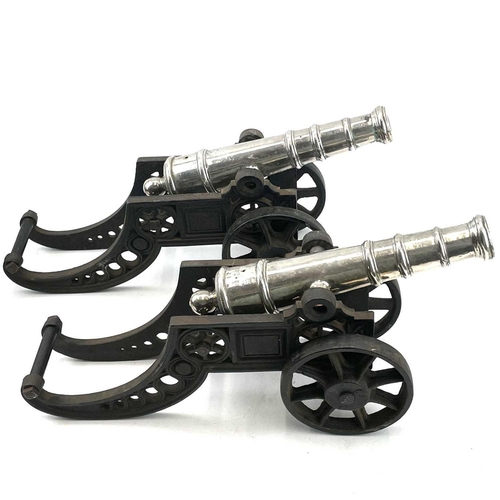 201 - A pair of model cannons, with silver plated finish on cast iron carriages, width 44.5cm (2).