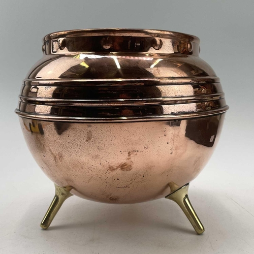 213 - A copper jardiniere, by Henry Loveridge, in the Christopher Dresser style, raised on three brass peg... 