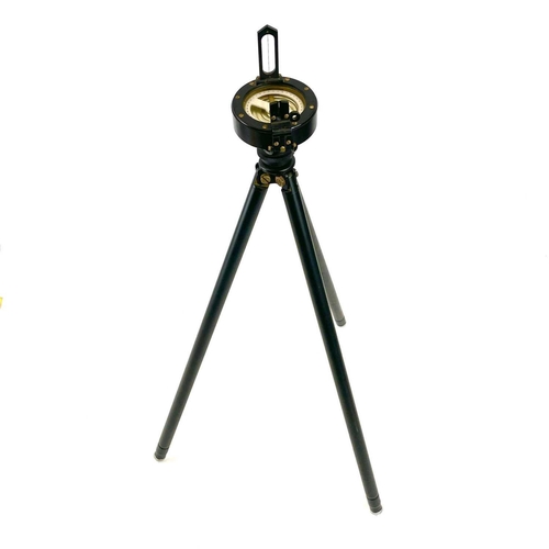 215 - A Surveyor's prismatic compass, diameter 8cm, together with a folding tripod, leather cased.