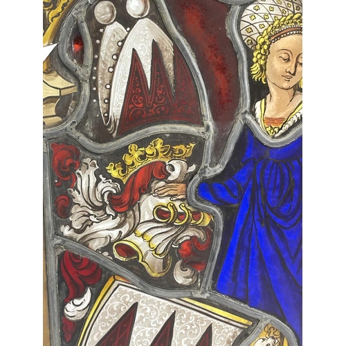 227 - A stained glass panel, 17th/18th century, depicting a lady in a blue dress with a dog at her feet, 3... 