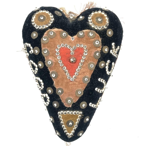 23 - An early 20th century soldier's sweetheart heart-shaped pin cushion, the black velvet covered obvers... 