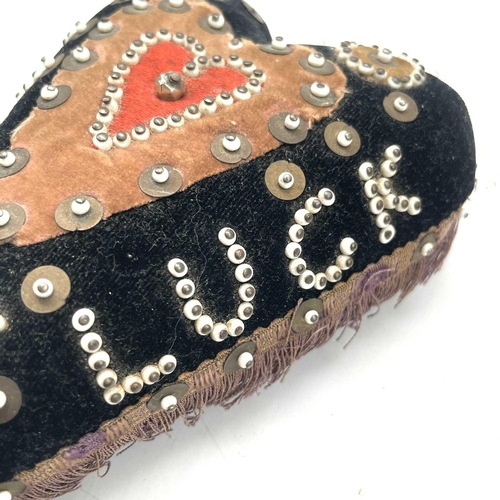 23 - An early 20th century soldier's sweetheart heart-shaped pin cushion, the black velvet covered obvers... 