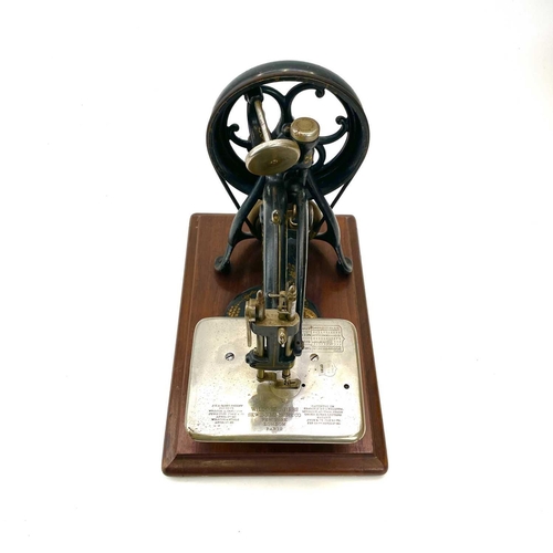 236 - A Willcox & Gibbs chain stitch sewing machine, circa 1885, with a small box of fittings and pine car... 