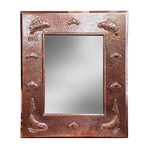 238 - A J & F Pool Hayle copper mirror, with bevel edge plate, the frame with planished finish and repouss... 