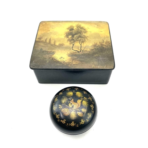 241 - A small circular Russian papier mache lacquer box decorated with a squirrel in a pine tree, diameter... 