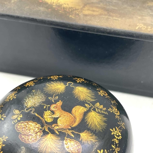 241 - A small circular Russian papier mache lacquer box decorated with a squirrel in a pine tree, diameter... 